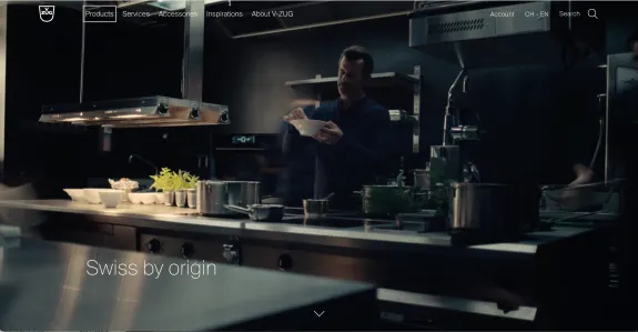 Chef cooking in a modern kitchen with Swiss branding visible