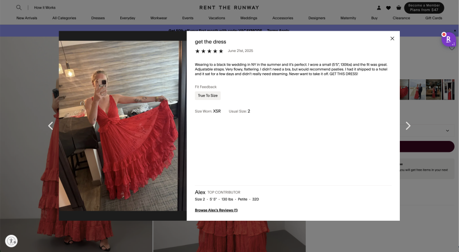 Woman taking a mirror selfie wearing a red dress with ruffles indoors.