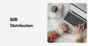 Person typing on laptop with coffee cup, labeled B2B distribution.