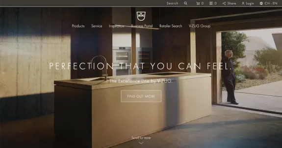 Modern kitchen interior with V-ZUG Excellence Line appliances and a person standing by the open door.