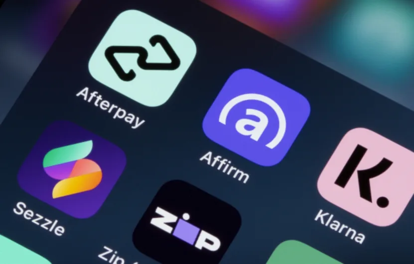 Close-up of buy now pay later app icons like Afterpay and Affirm on a screen.