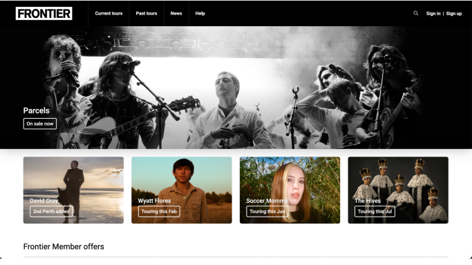 Band performing on stage with Frontier Touring promotion and member offers.