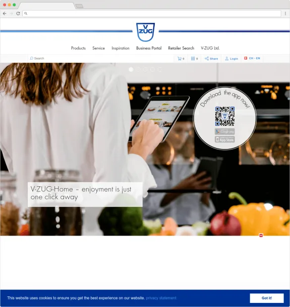 Person using a tablet in a kitchen setting with QR code for V-ZUG app download.