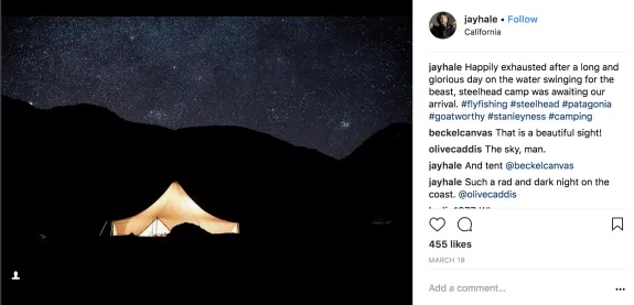 Illuminated tent under a starry sky at night, perfect for camping.