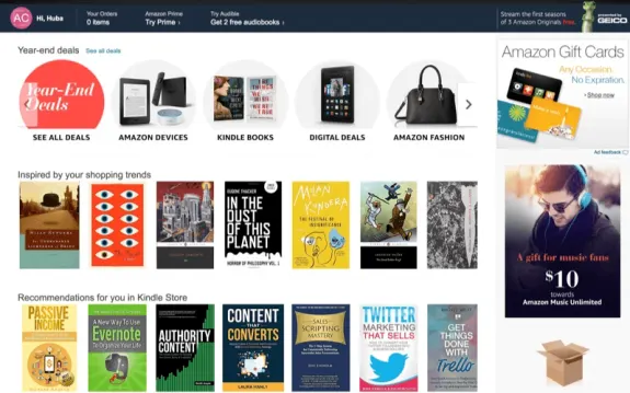 Amazon homepage with year-end deals, Kindle and book recommendations, and gift card offer.