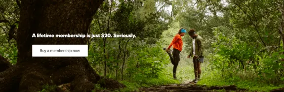 Couple stretching in forest with membership offer for $20