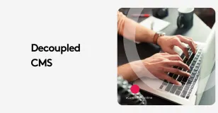 Hands typing on a laptop keyboard with the text 'Decoupled CMS' on the side.