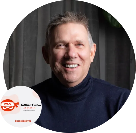 Smiling man in dark sweater with digital assassin logo in background