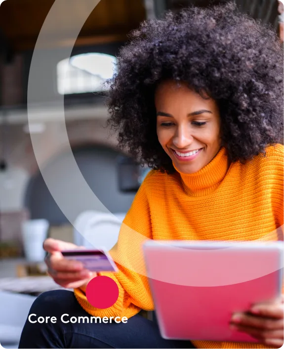 Woman in yellow sweater shopping online with tablet and credit card in cafe.