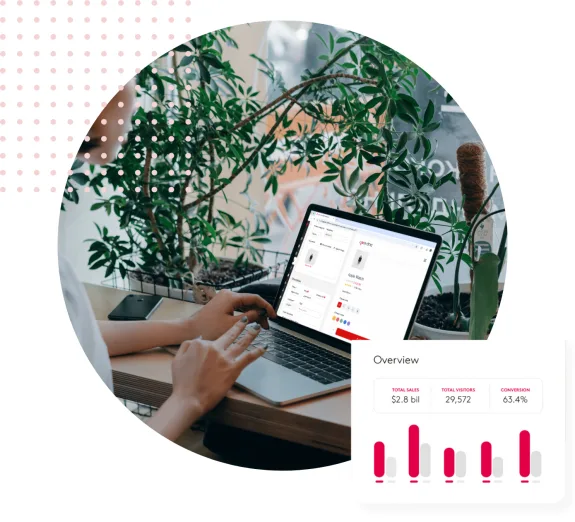Person using a laptop with a digital marketing dashboard in a plant-filled workspace.