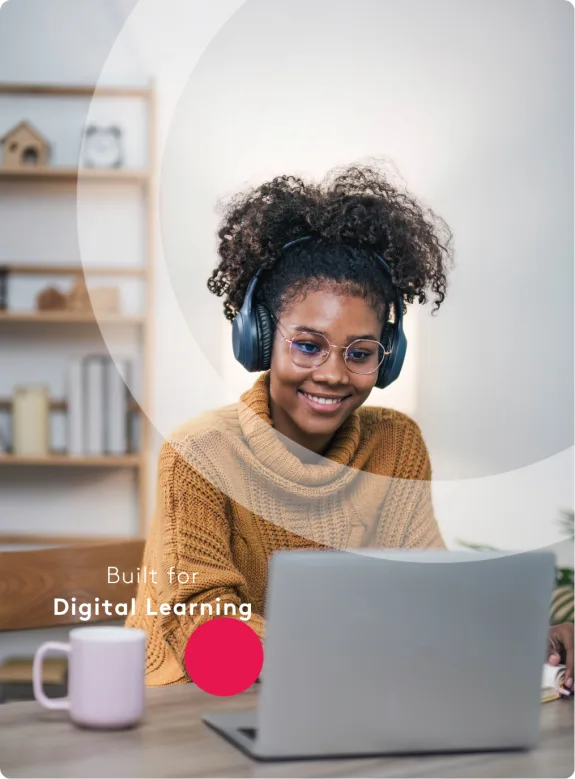 Woman wearing headphones and glasses using laptop for digital learning